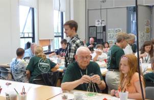 Photo of grandparents working with students on a landscape architecture project during MSU Grandparents University.