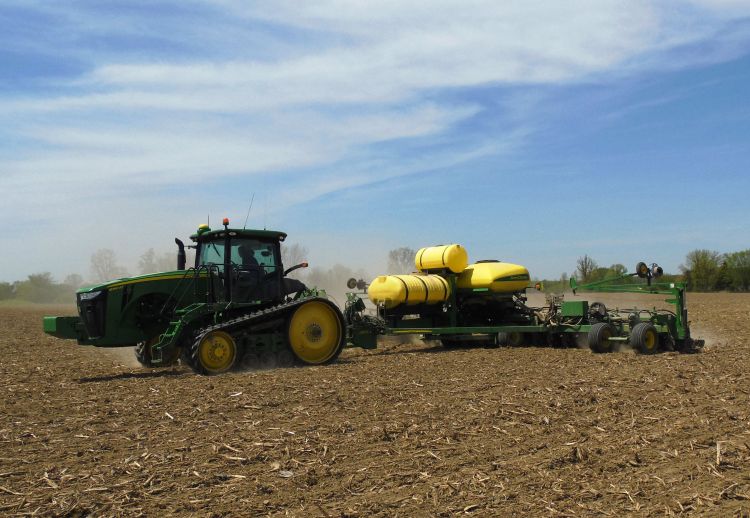A soybean planter planting soybeans in a field.