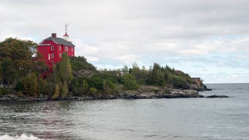 Photo of a peninsula and house surrounded by water.