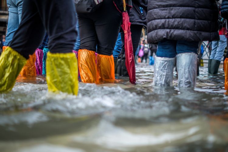People standing in flooded street