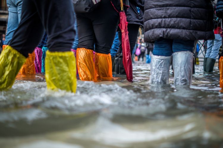 People standing in flooded street