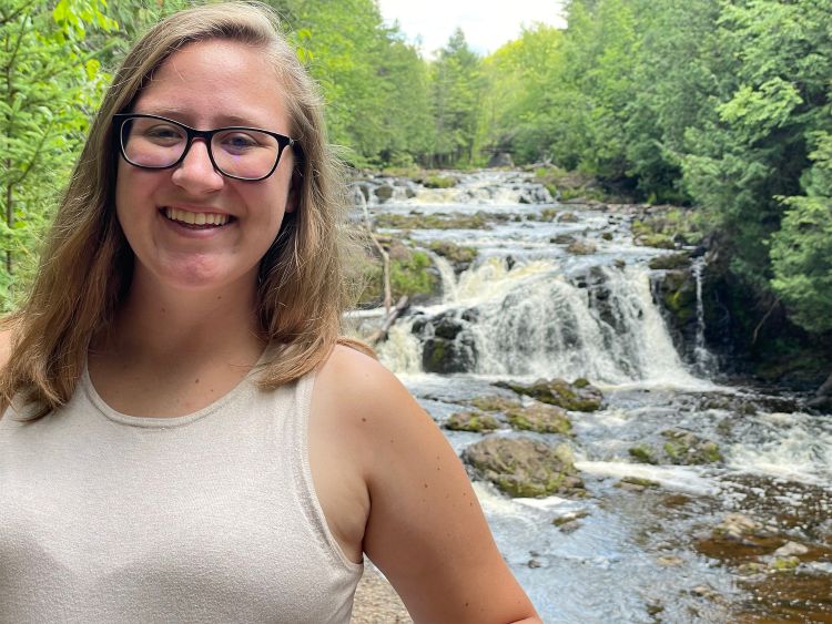 Ashley Wright standing in front of a waterfall
