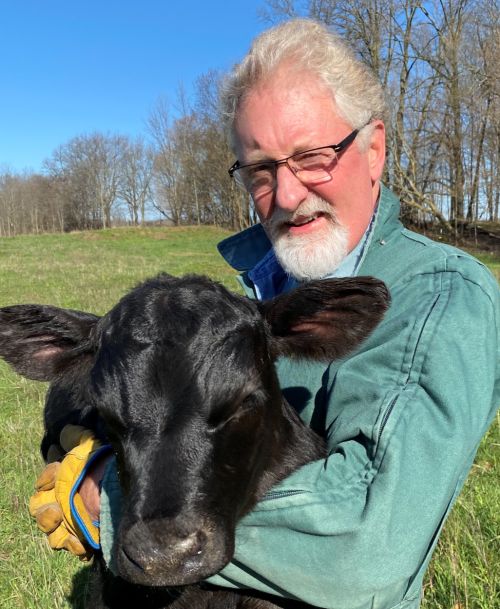 Mike VandeHaar holding a calf.