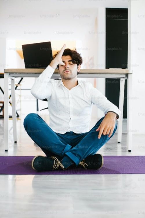 A man being mindful in an office setting.