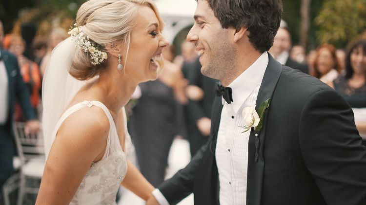 Newlywed couple smiling.