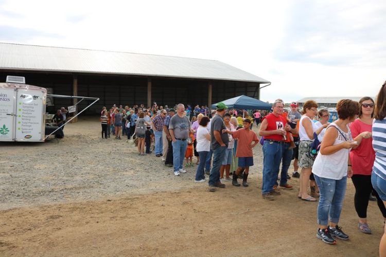 The crowd standing in line for breakfast, shaking whipping cream to make the butter for their pancakes. Photo Credit:A. Kuschel.