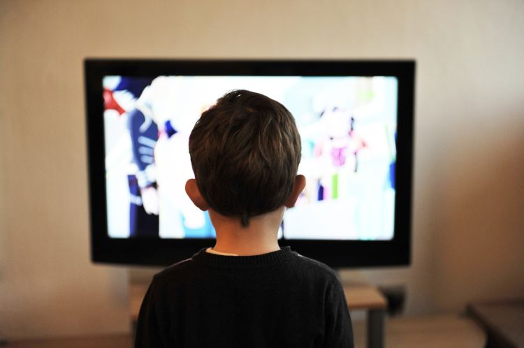 A boy watching TV.