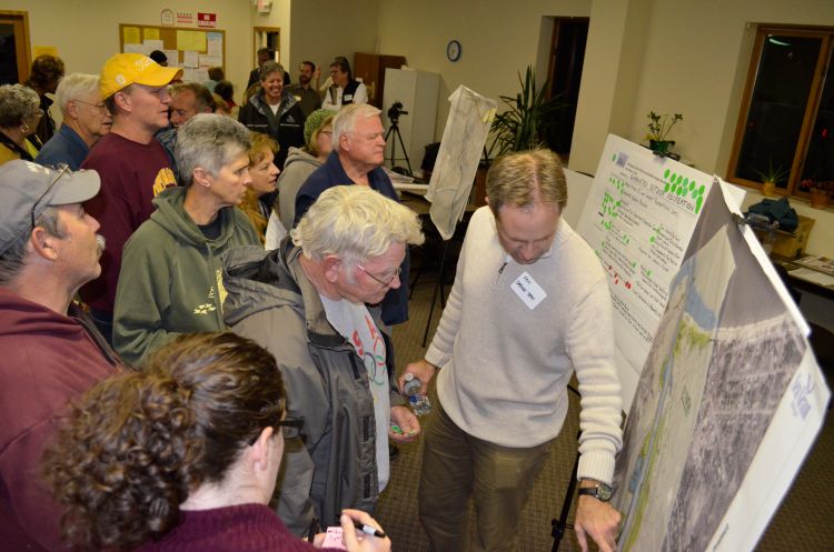 Community members review the design alternatives during the charrette open house; Photo credit: Todd Marsee