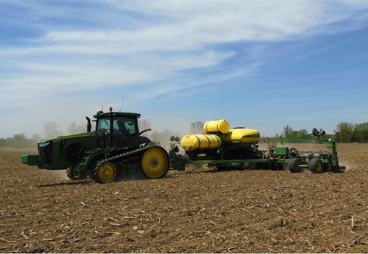 Tractor planting soybeans