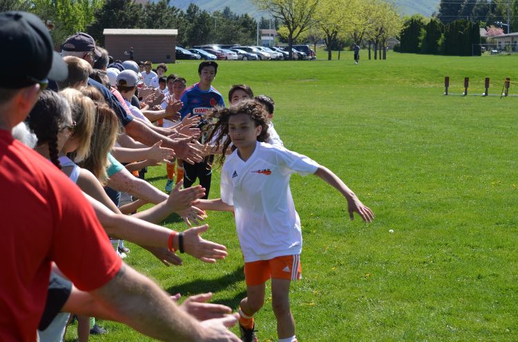 A soccer team shaking hands