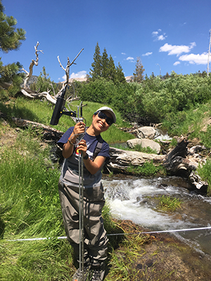 Sophia Chau standing in waders