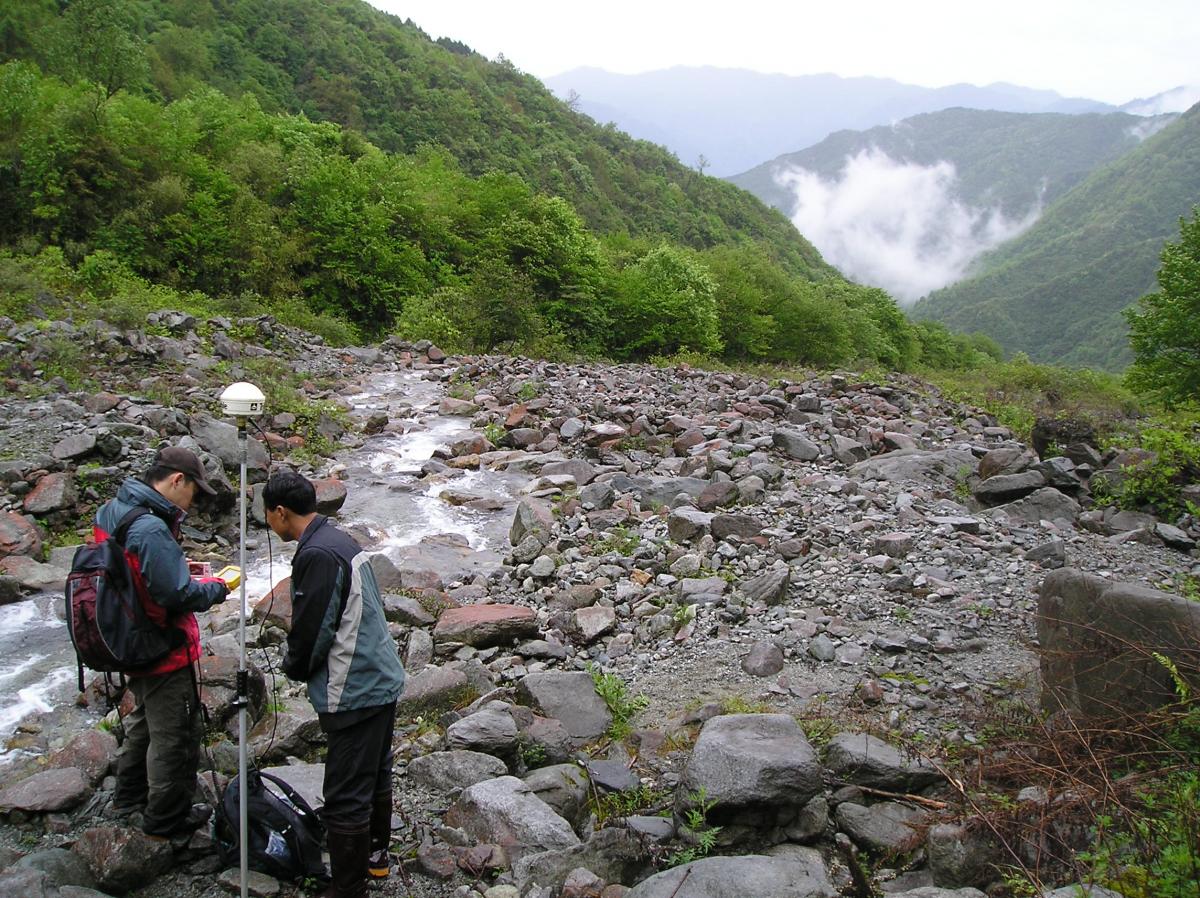Taking measurements in a river in Wolong Nature Reserve