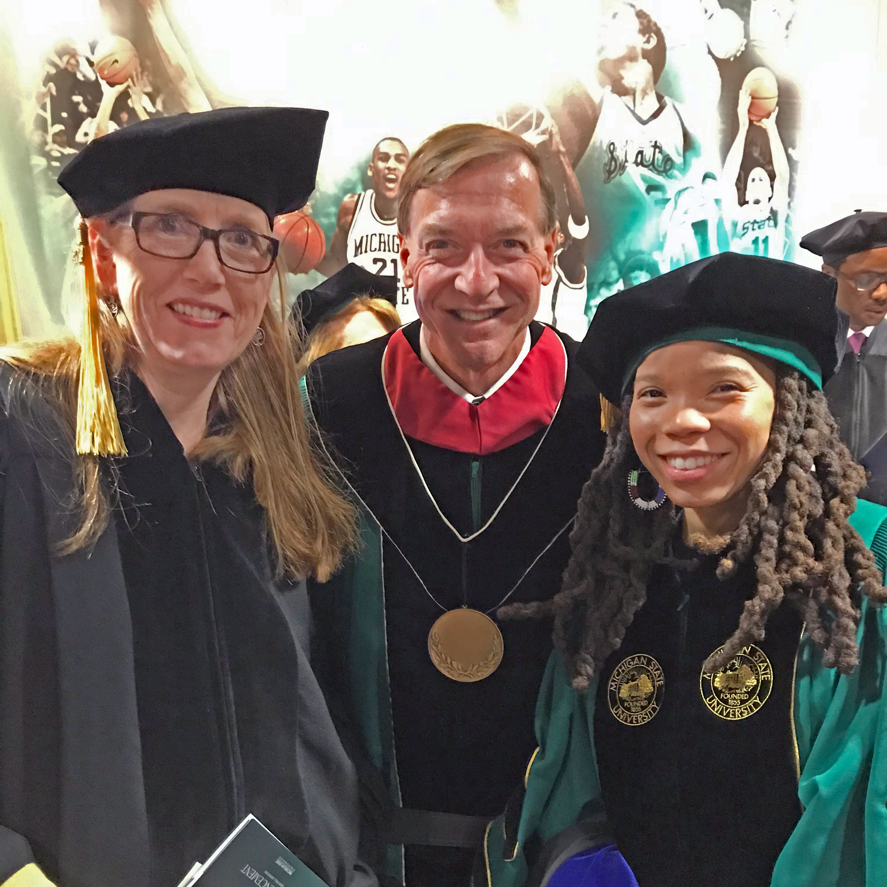 Two CSUS graduate students at the MSU Advanced Degree Commencement with President Stanley