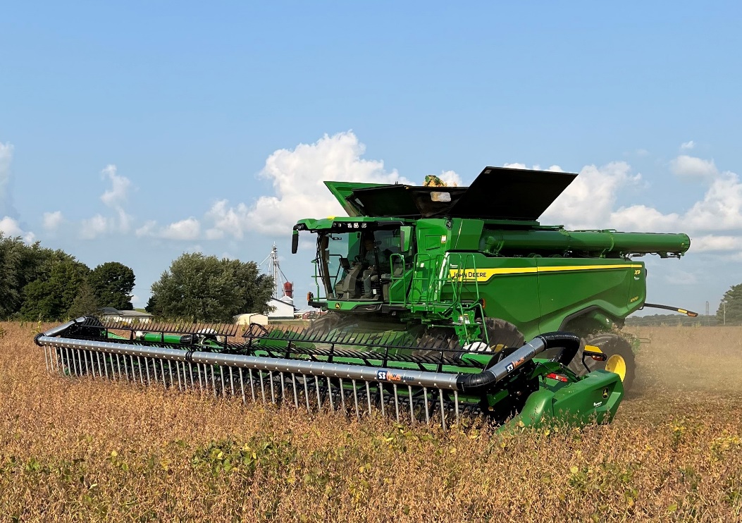 John Deere combine in a soybean field