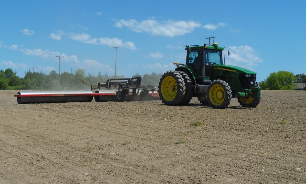 Tractor pulling a land roller
