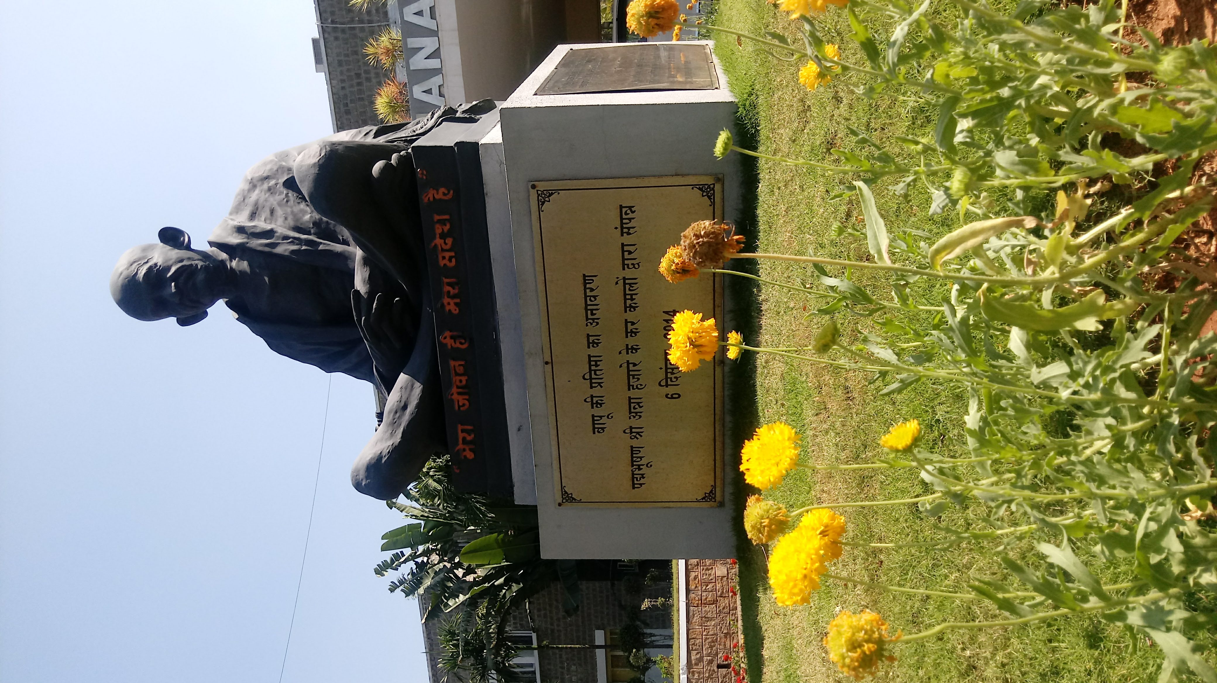 Photo of outside statue of Budha on outdoor campus