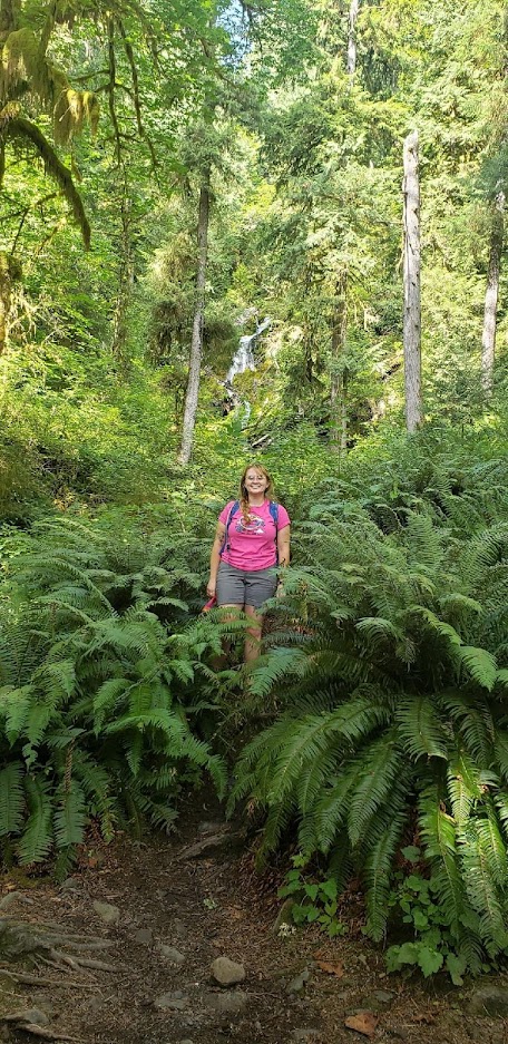 Cheyenne standing in front of ferns.