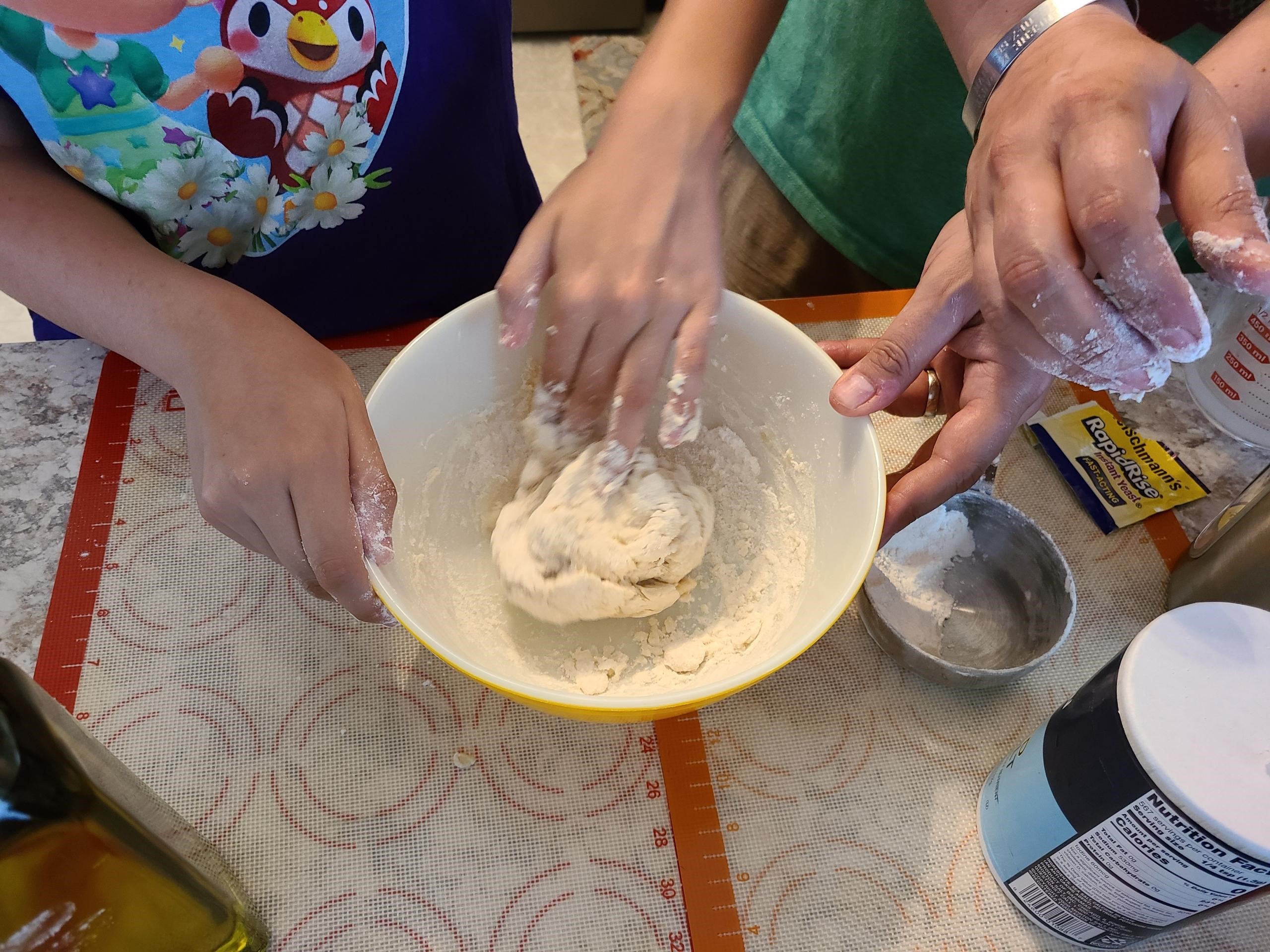 Participant knead pizza dough.