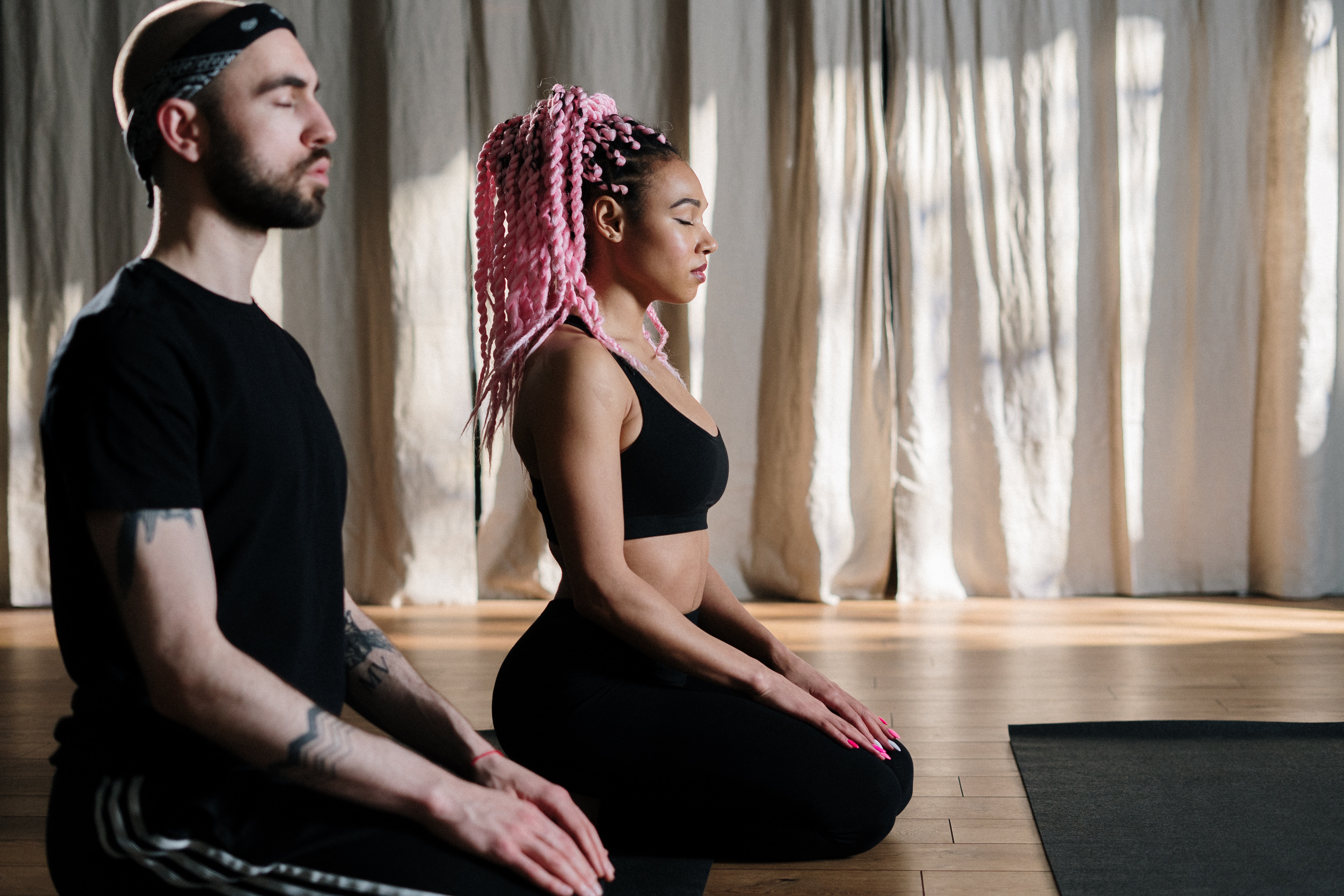 A picture of two people doing yoga.