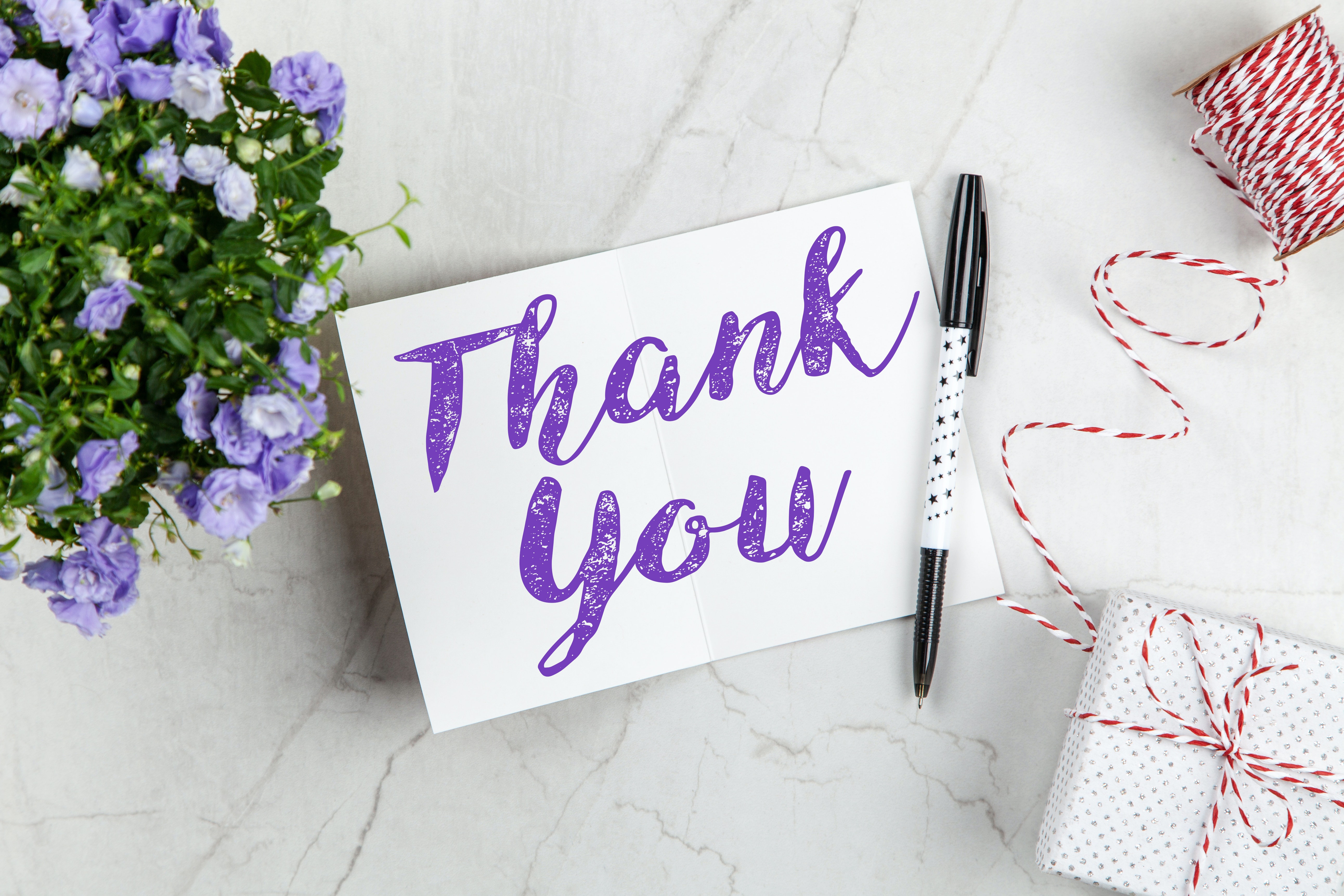 Picture of a thank you note and flowers.