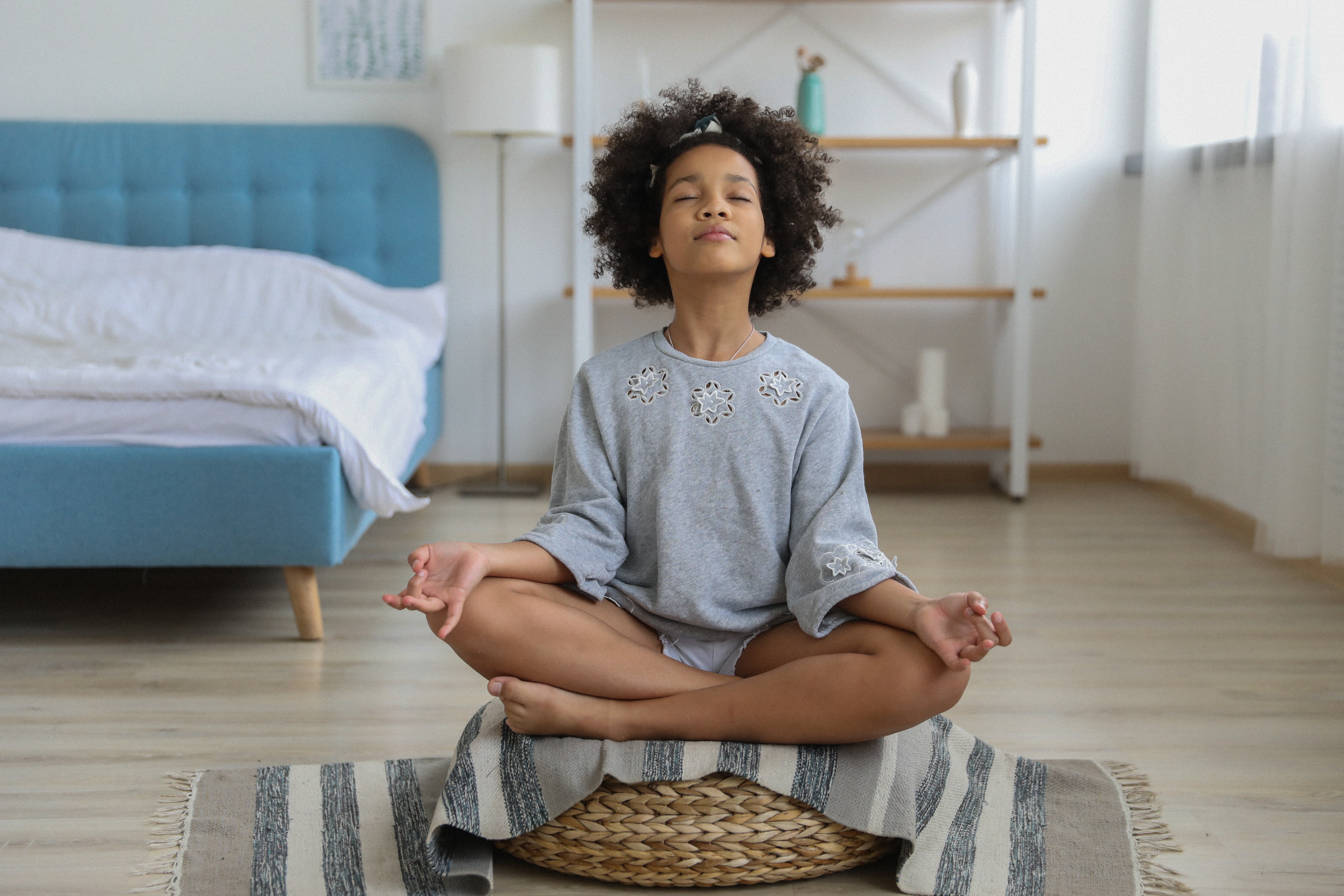 A picture of a teenager meditating. 