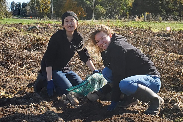 Two students condicting research in a field
