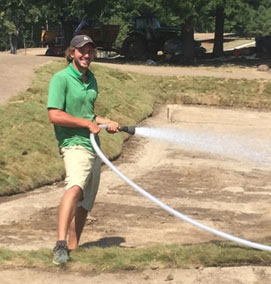 Timothy LeBlanc waters grass.