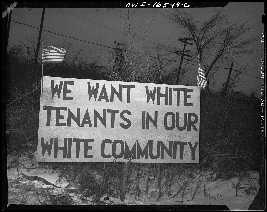 A 1942 sign from Detroit, MI highlights racist opposition to a federal housing project by neighboring residents.