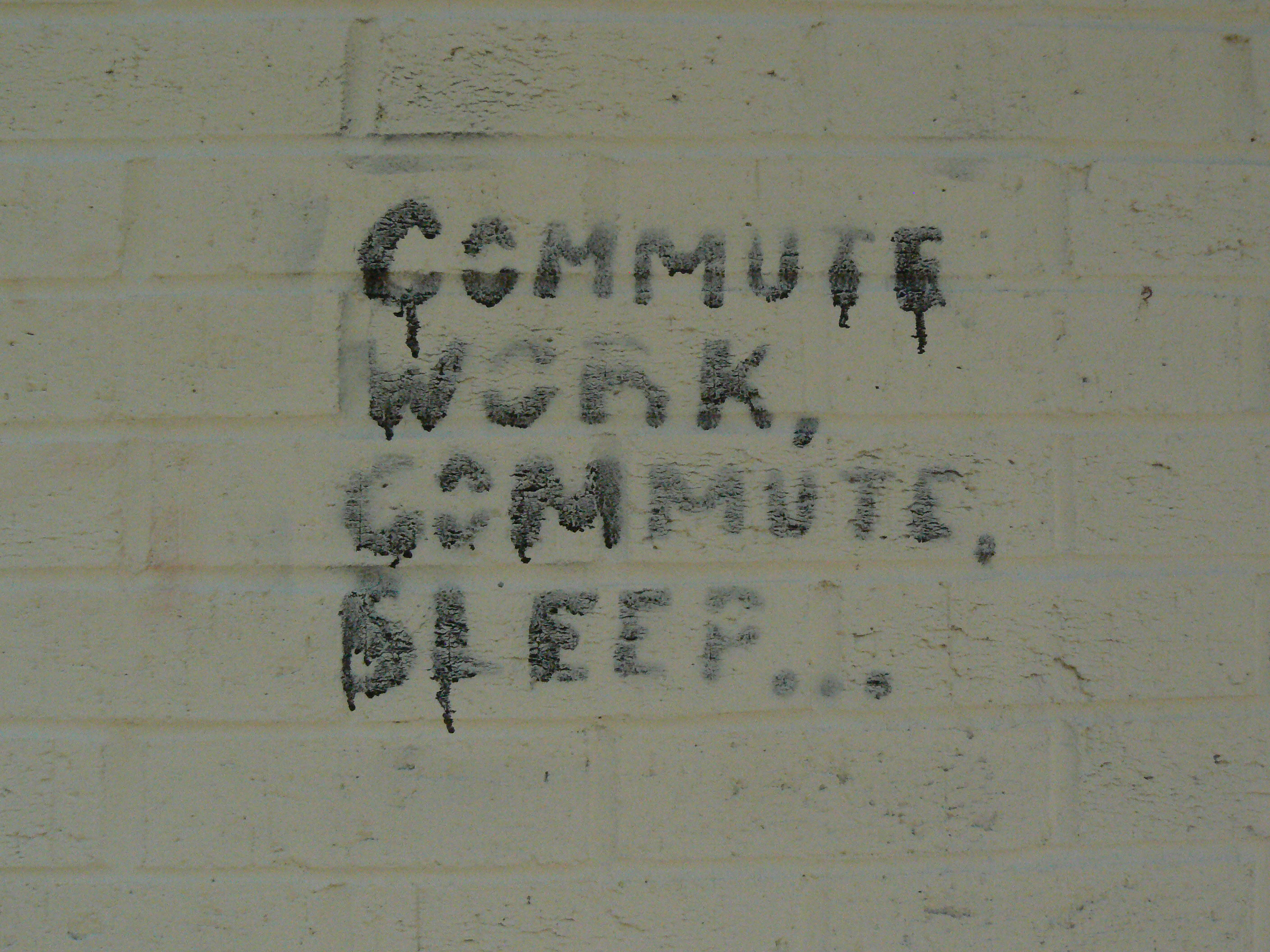 Commute Work Commute Sleep painted on white wall