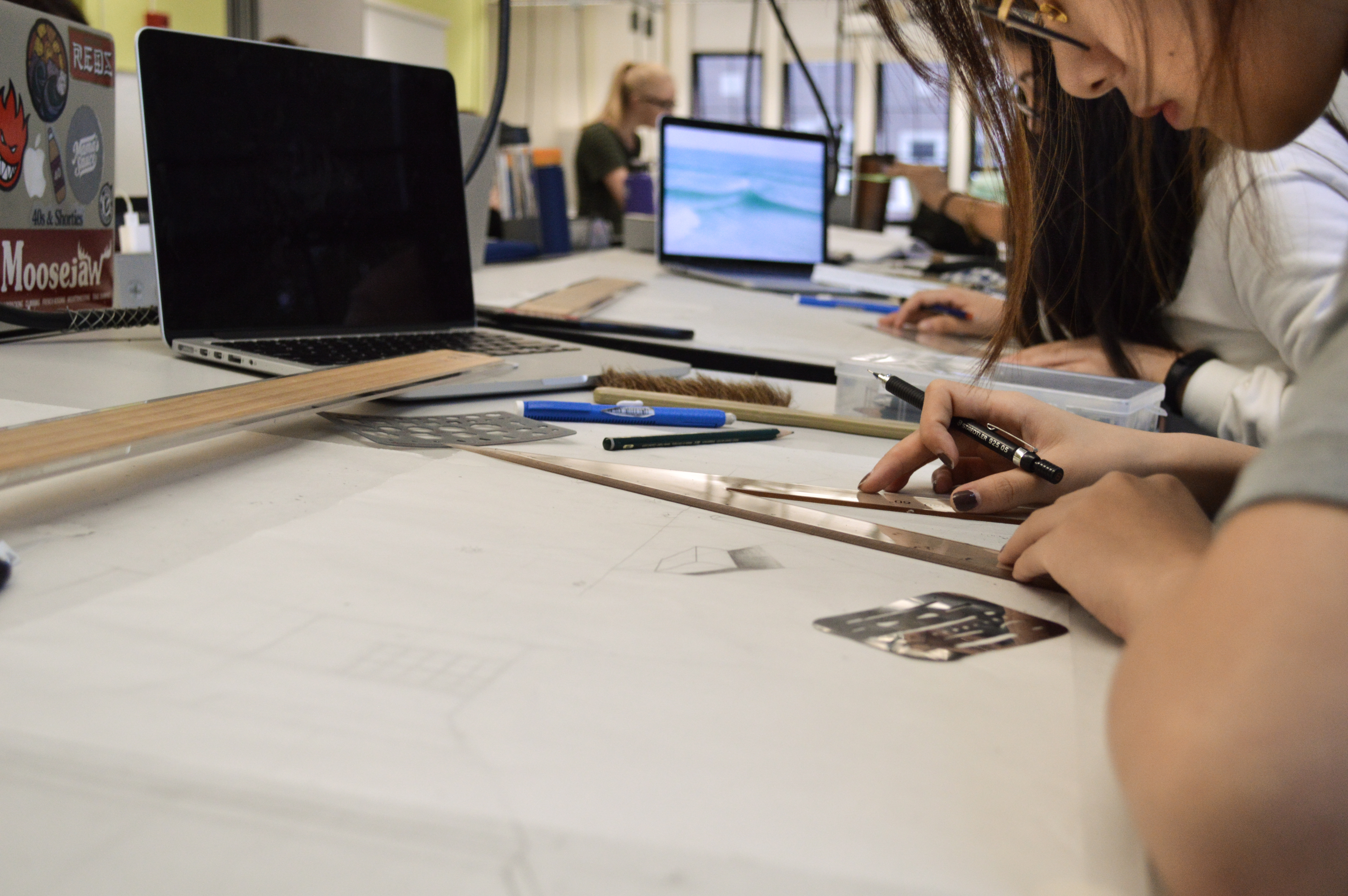 Interior Design students working on design rendering drawings in the classroom.