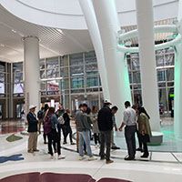 Photo of students at a train station terminal.