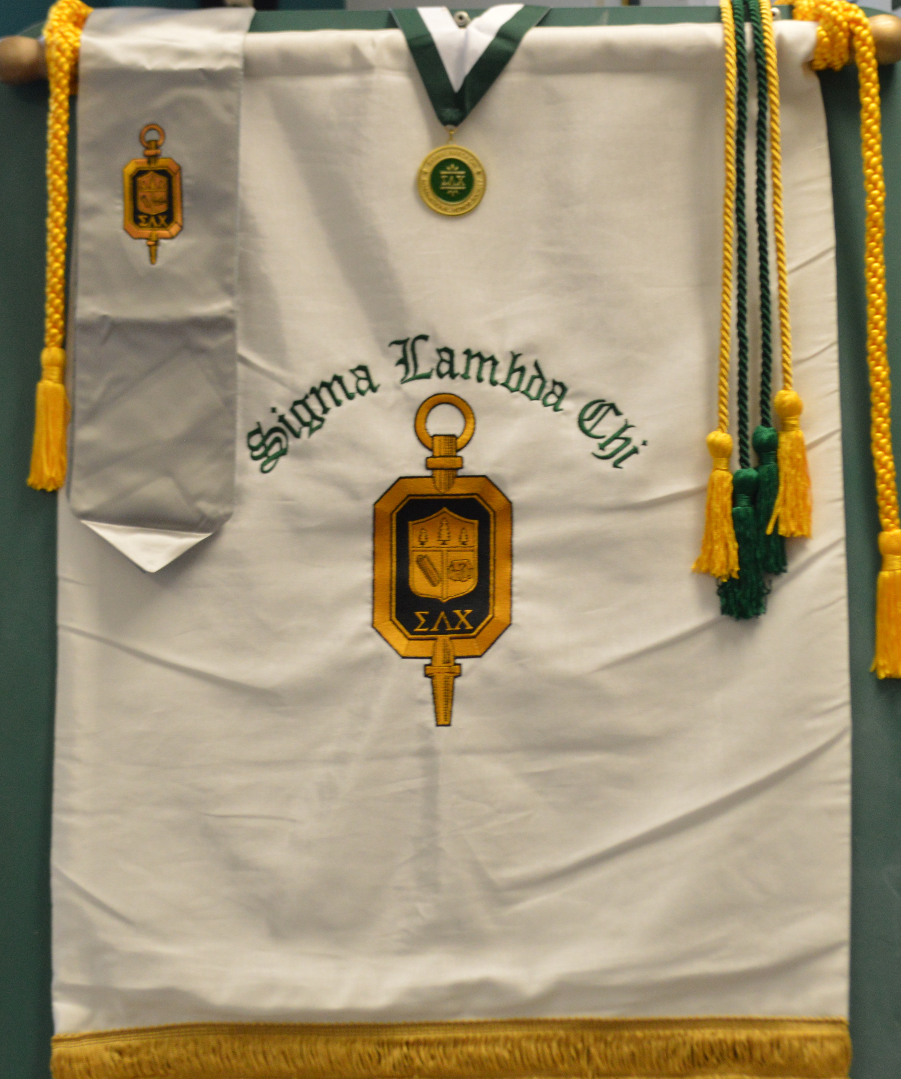SLC official honor society banner with graduation tassles and medal that are usually presented to new members.