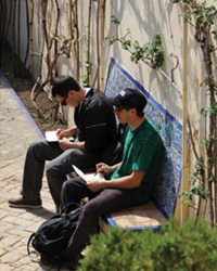 Two students drawing at Alcázar de Sevilla, Seville, Spain.