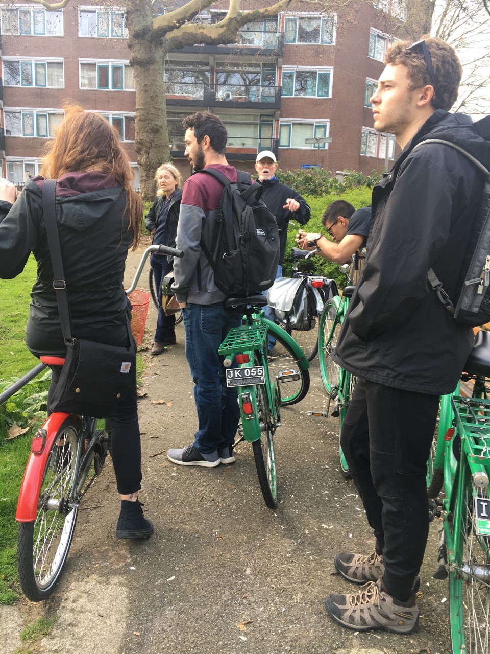 Students standing with bicycles.