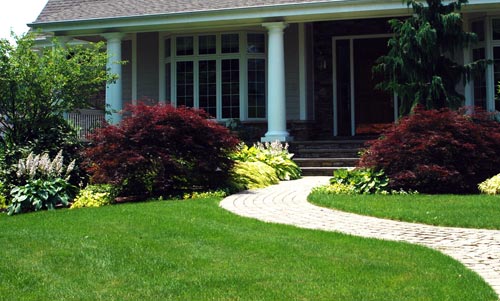 Front of a house with beautiful landscaping.