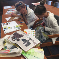 Grandparent and grandchild working on an interior design project