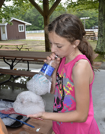 Girl blows a bubble