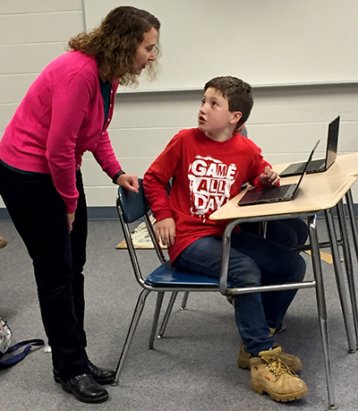 Youth explaining their code to MSU Extension Science Educator