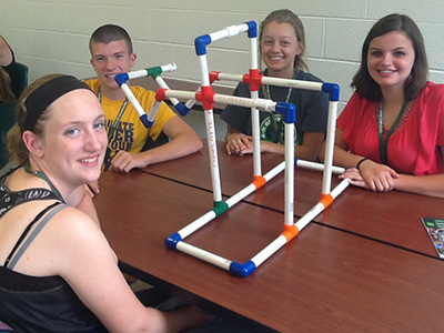 Youth building catapults with PVC