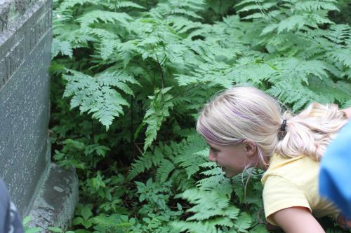 GIRL LOOKING AT HEADSTONE