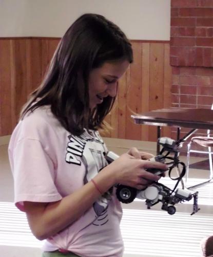 Teenage girl working with robotics.