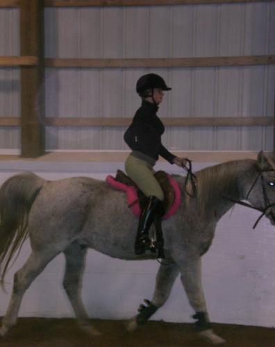 Horseback riding with shoulders even shoulders, centered in saddle.