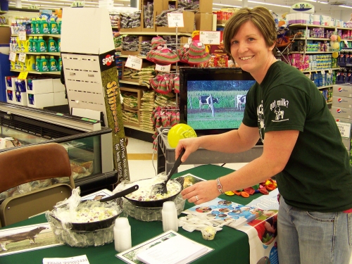 Katie Deller serving up summer fruit salad at “Farming for You”