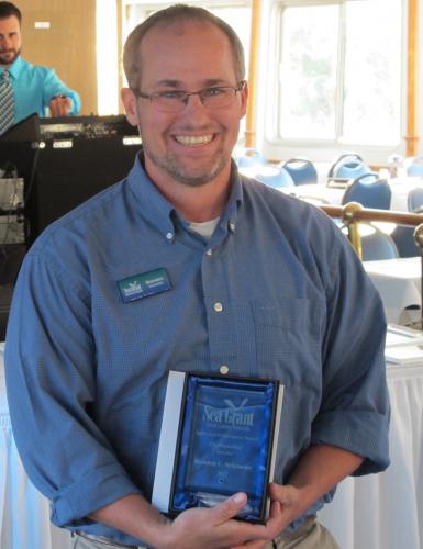 Brandon Schroeder accepts an award