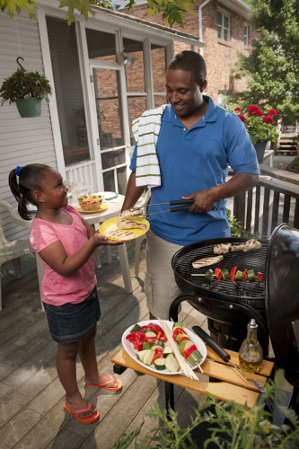 Many and child grilling