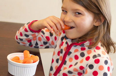 Little girl eating carrots