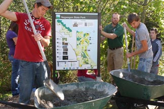 Students installing Negwegon Park sign