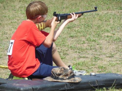 Boy competing in air rifle competition