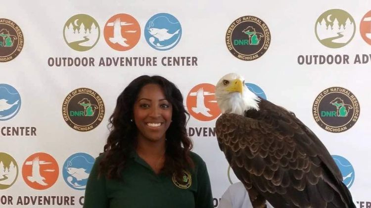 Alexis Hermiz poses with an eagle.