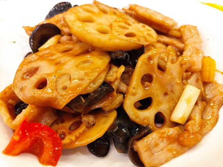Roots of the sacred lotus, an invasive plant in the Midwest, are stir-fried with soy sauce, peppers, and wood ear mushrooms.
